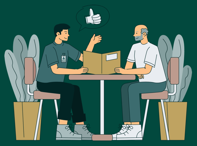 Twee mensen in gesprek aan tafel tijdens een HR-gesprek